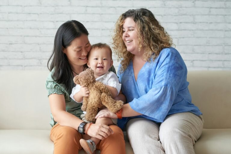 Diverse Lesbian Couple sitting with Child
